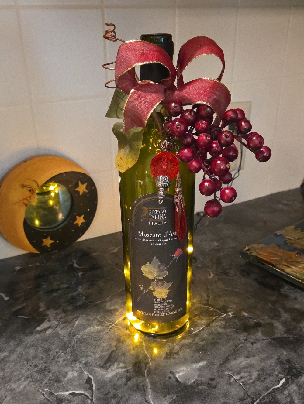 Illuminated Red Holiday Wine Bottle with Berries, Bow And Jewels